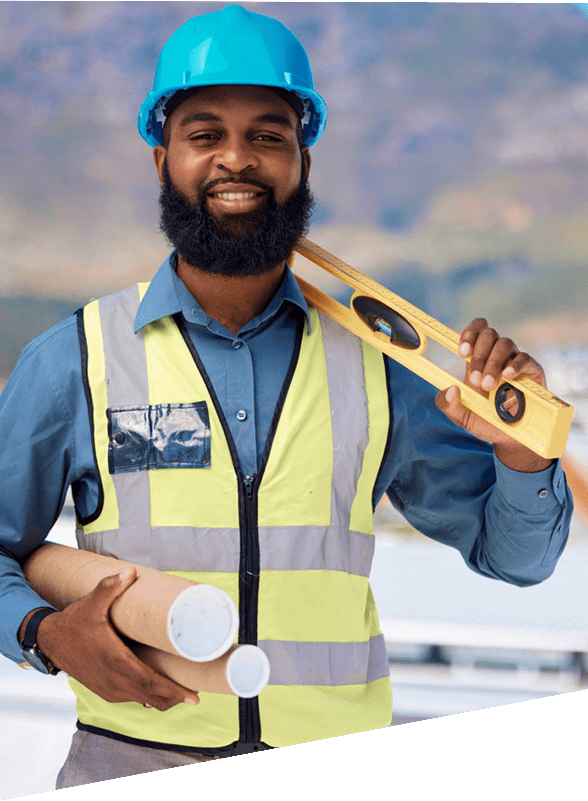 Smiling construction worker holding blueprints and level.